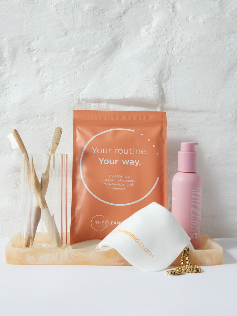 Cleansing cloth on bathroom counter with products